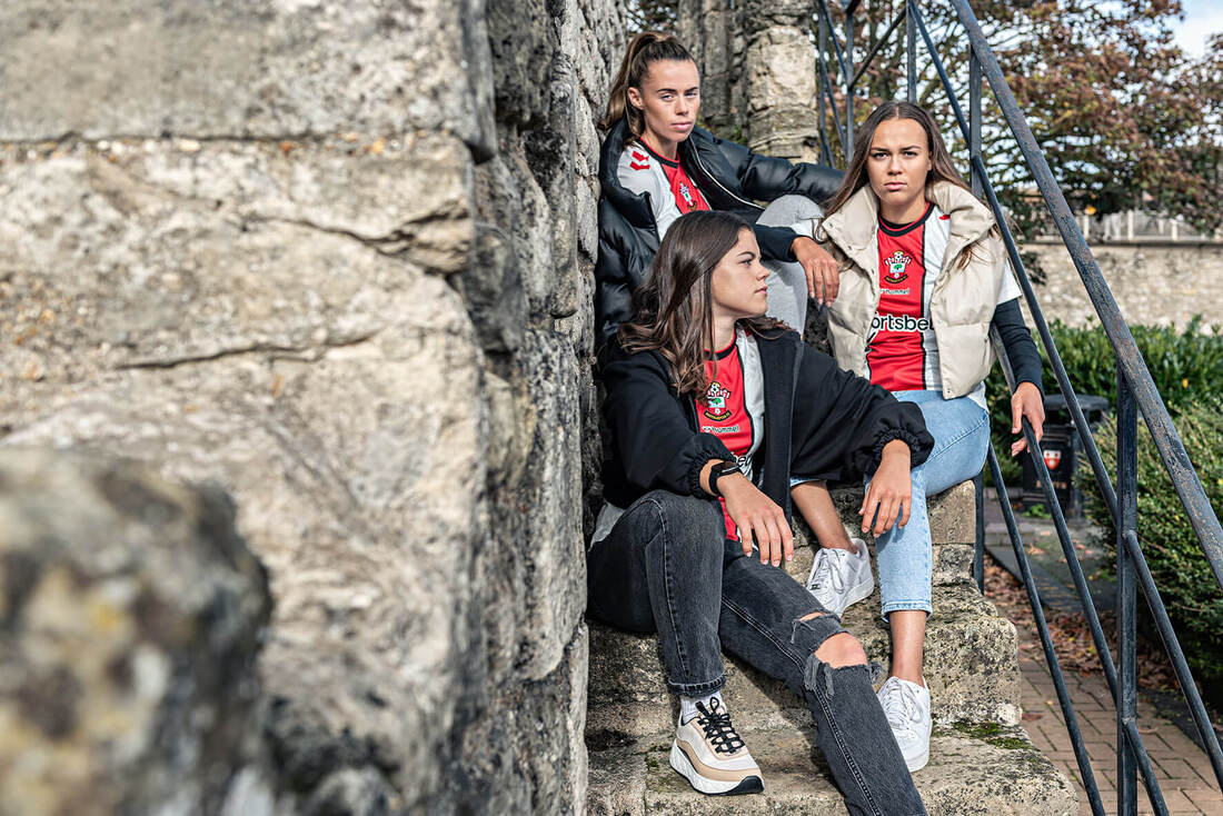 southampton fc ladies players sitting on stone steps